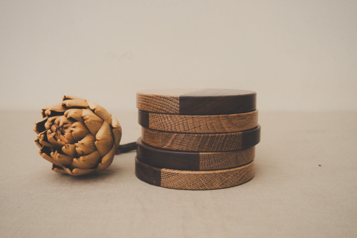 A pile of two-toned wooden coasters.